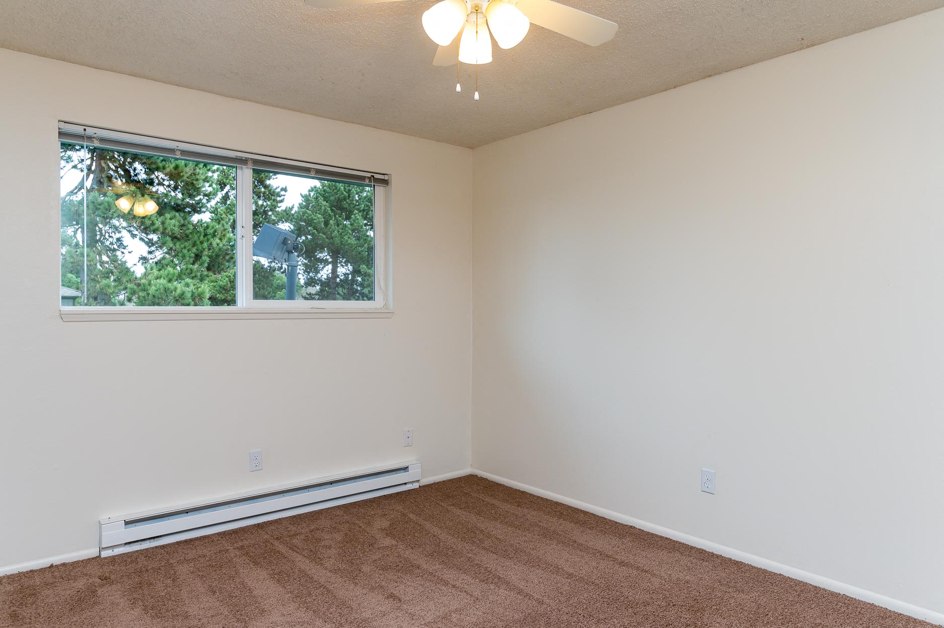 Pinewood Terrace Apartments | First bedroom with carpet and window
