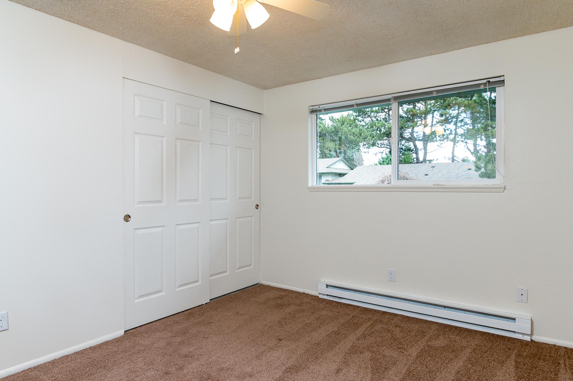 Pinewood Terrace Apartments | First bedroom showing closet doors and window