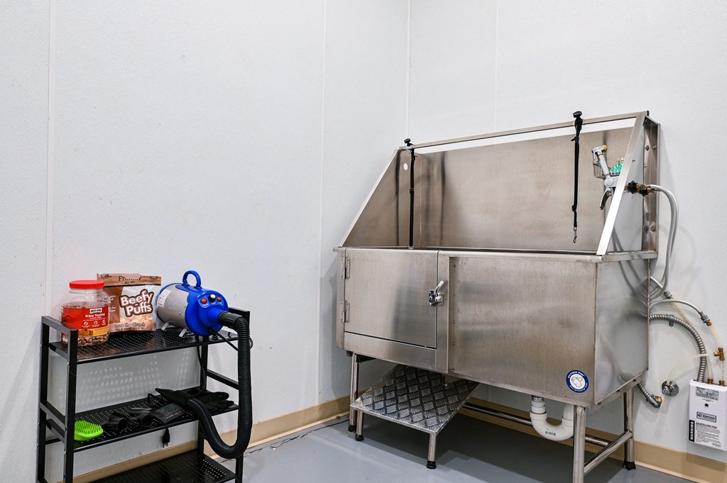 a large stainless steel sink in the corner of a room