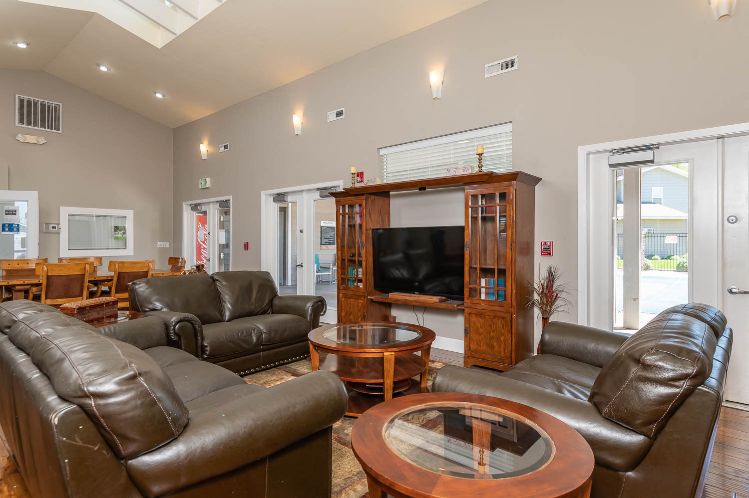 a living room with leather furniture and a television