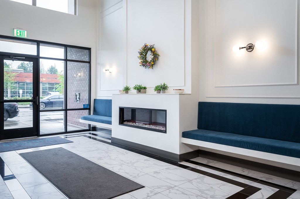 a living room with a fireplace and blue couches