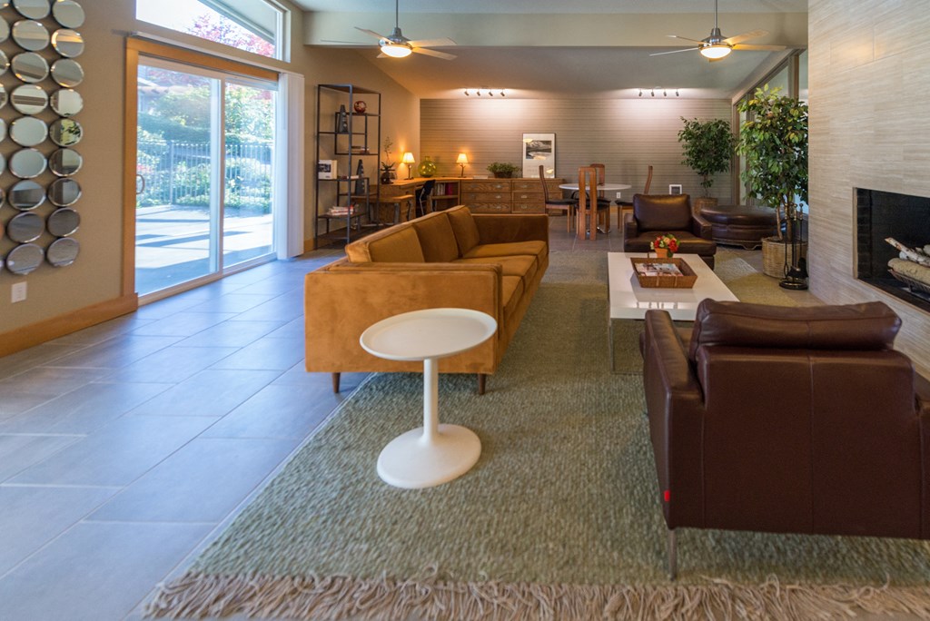 a living room with couches a table and a fireplace