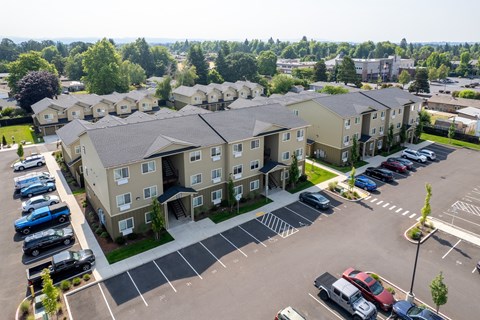 A parking lot in front of apartment buildings.