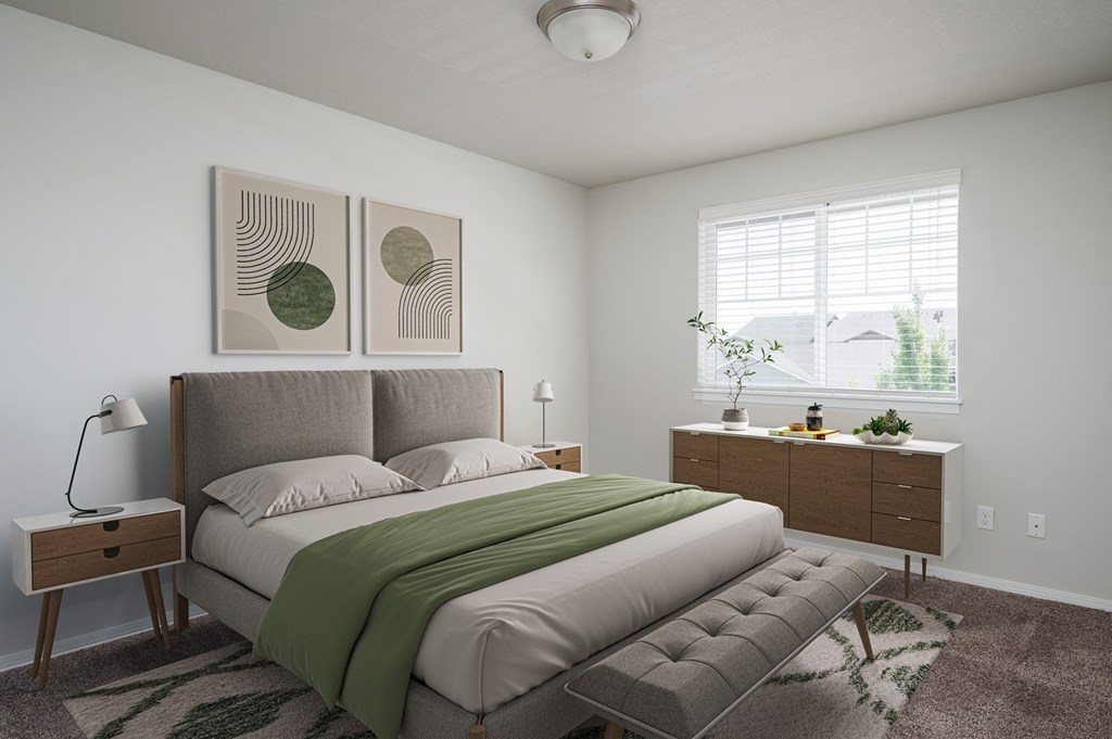 A bedroom with a large bed and two nightstands.