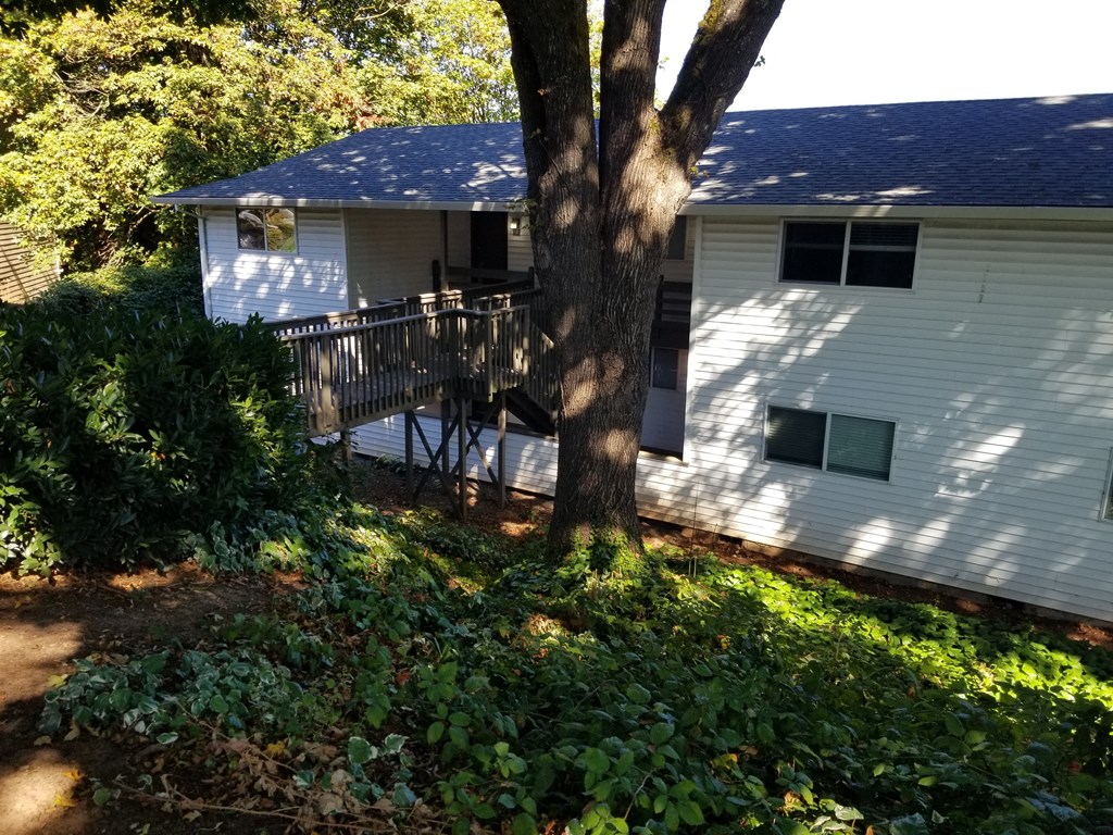 a view of the back of a house with a deck
