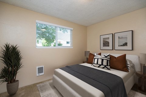 a bedroom with a bed and a window