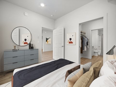 a bedroom with a large bed and a mirror