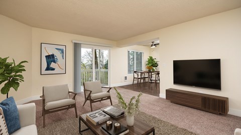 A living room with a television, chairs, and a coffee table.