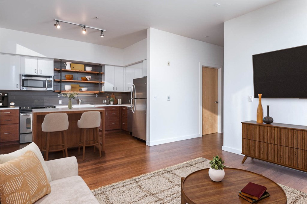 A modern kitchen with a dining table and chairs.