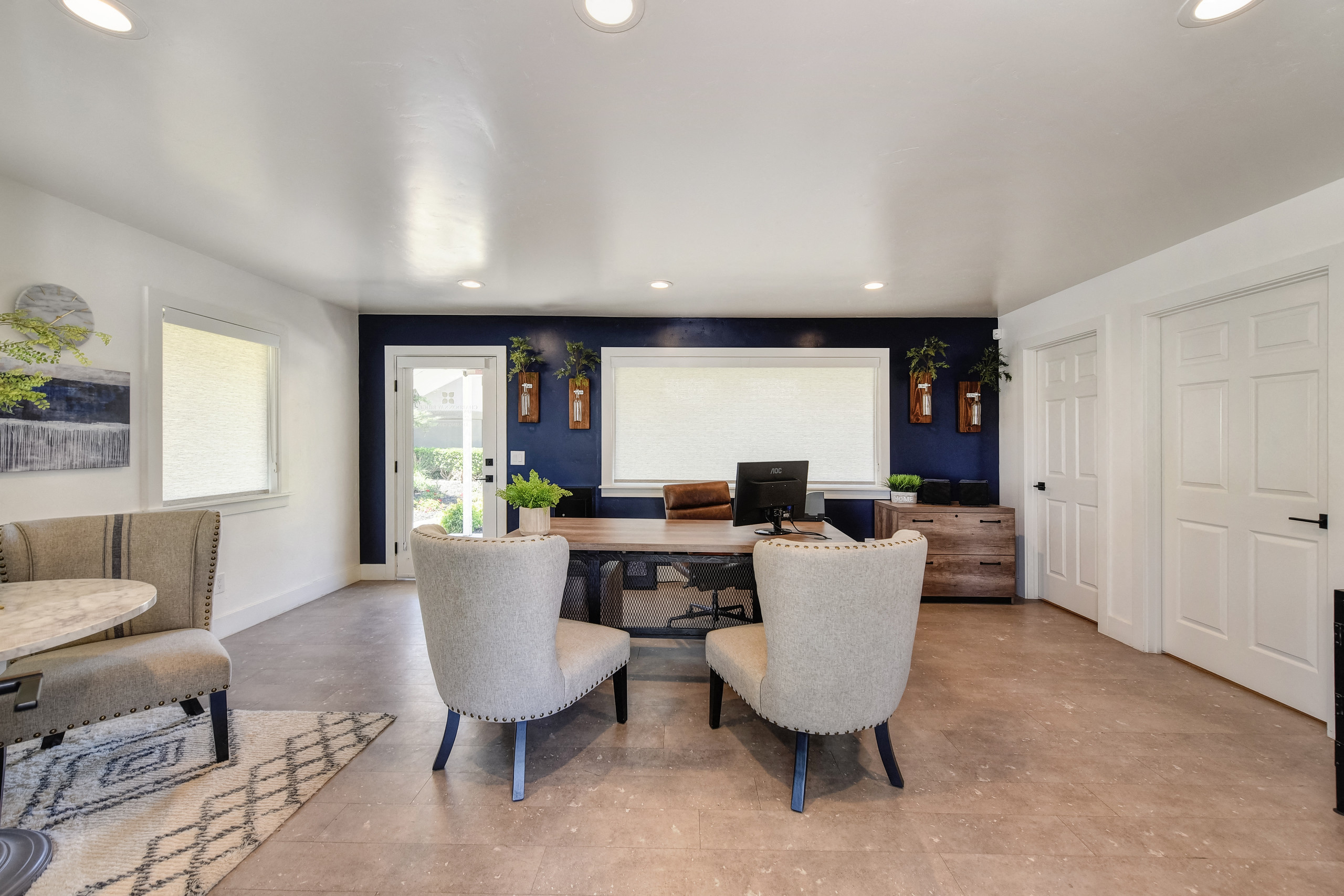 a living room with a dining room table and chairs