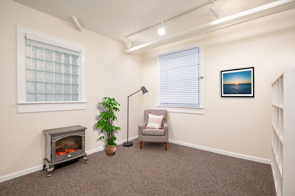 a living room with a fireplace and a chair