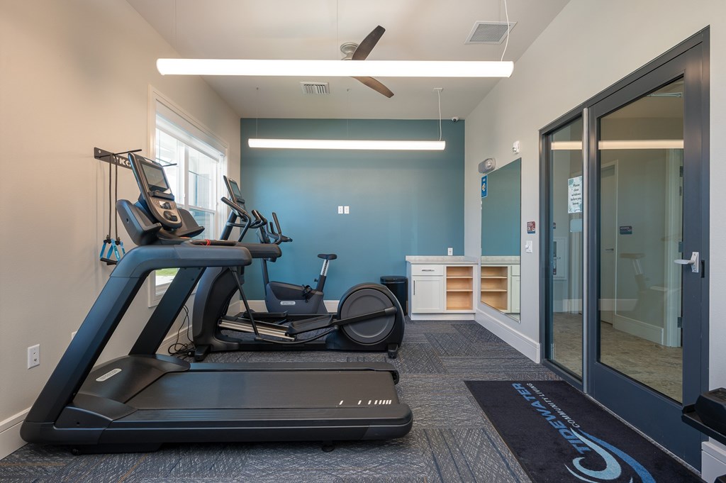 fitness center with treadmill and elliptical