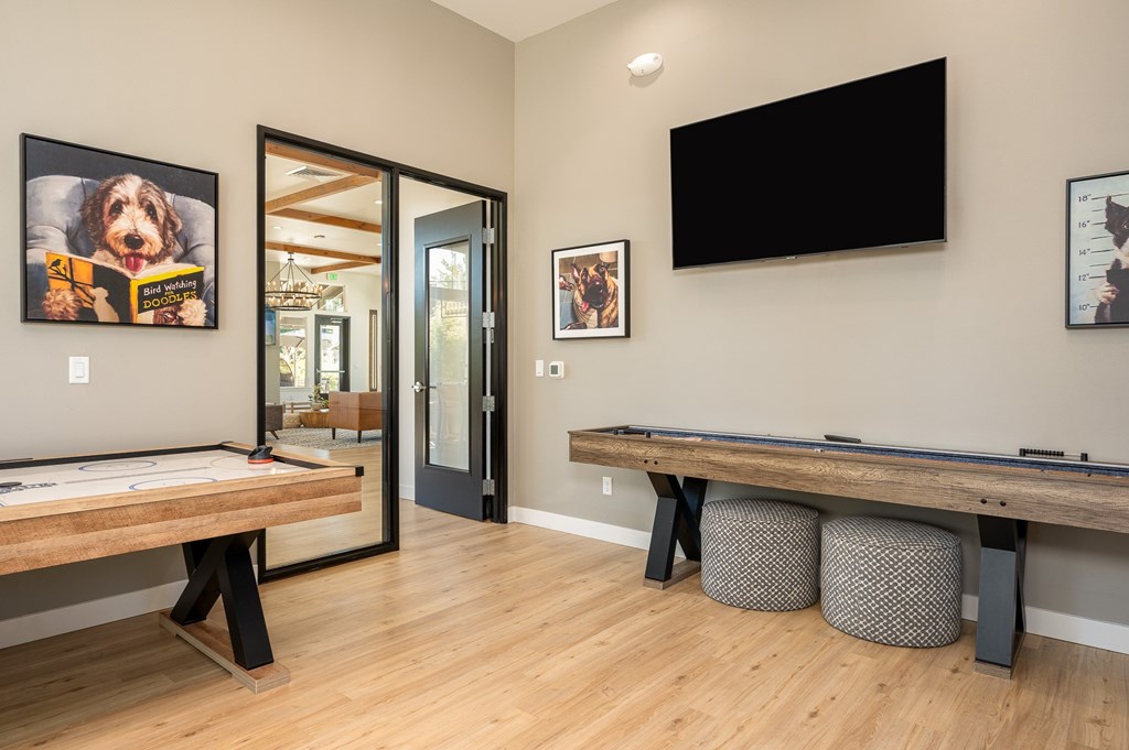A room with a pool table and a television.