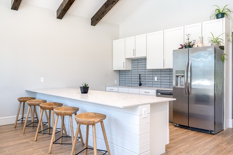 clubhouse kitchen with a white counter and a refrigerator.