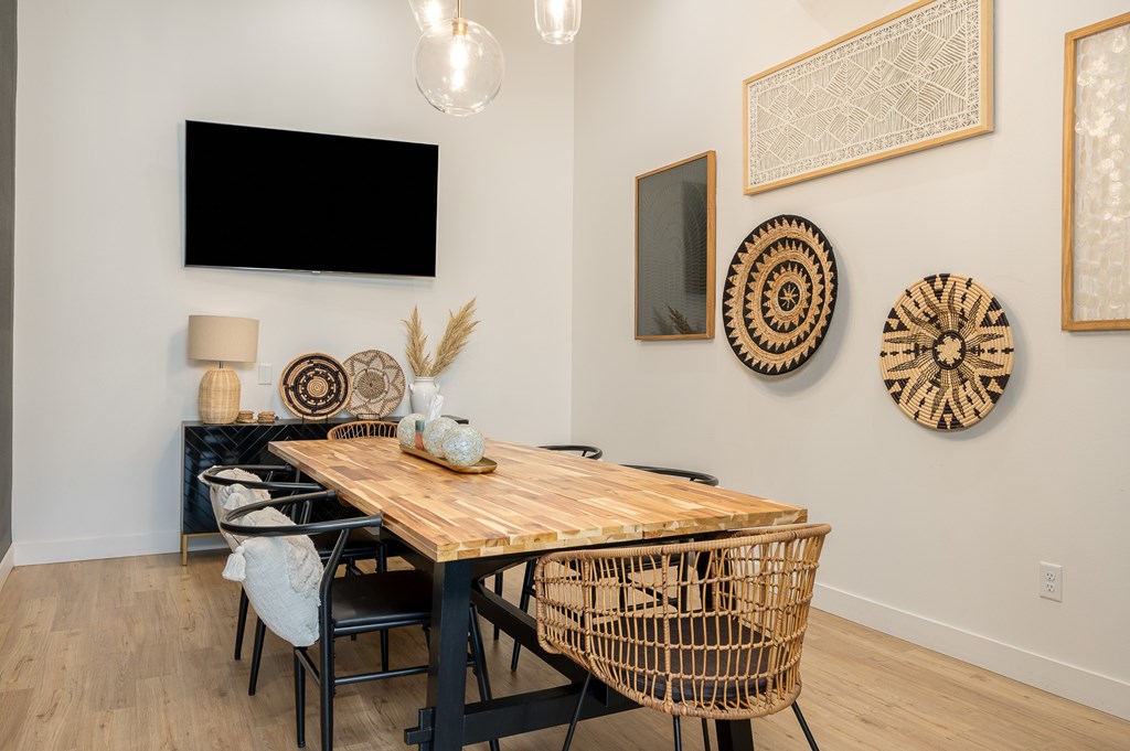 A dining room with a wooden table and chairs.