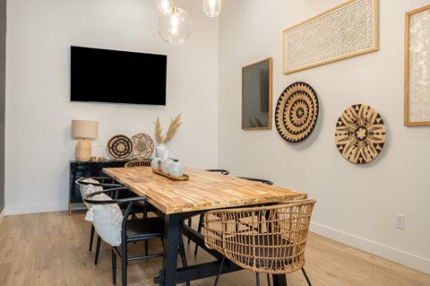A dining room with a wooden table and chairs.