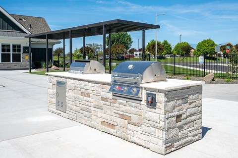 outdoor grill and cooking area next to pool