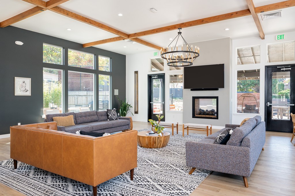 A living room with a grey couch and a brown sofa.