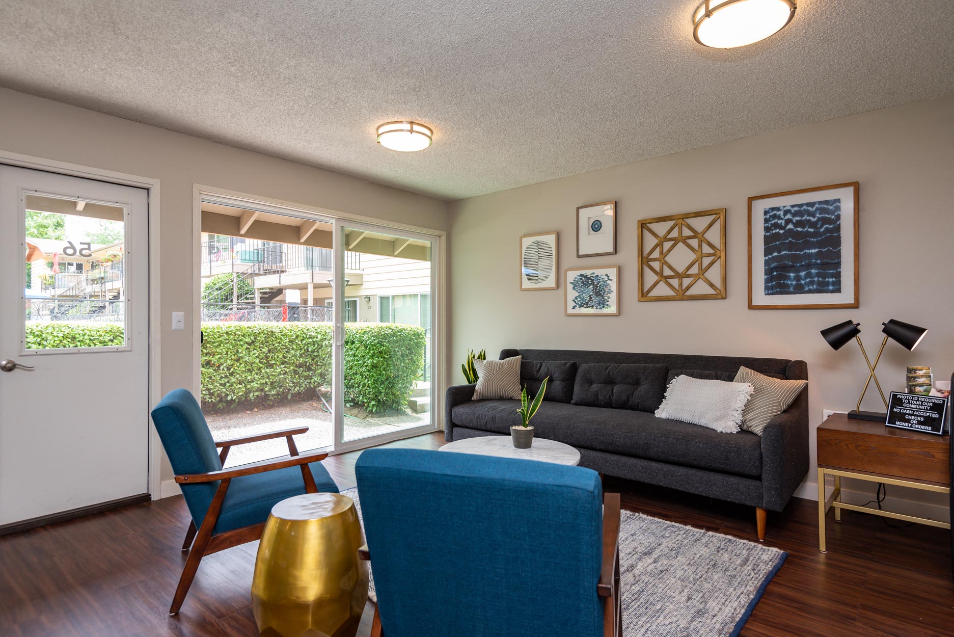 a living room with a couch and chairs and a sliding glass door