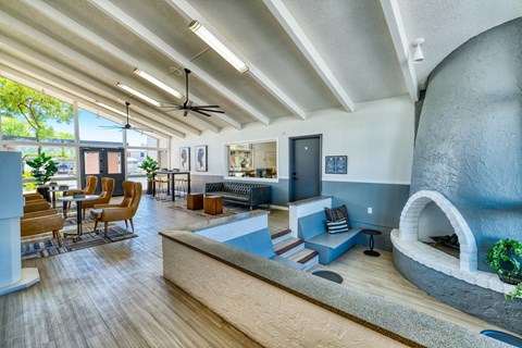 a living room with a fireplace and a table and chairs