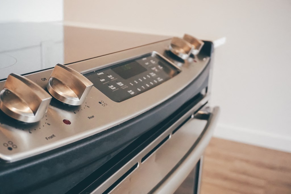 a kitchen with an oven with two silver knobs on it