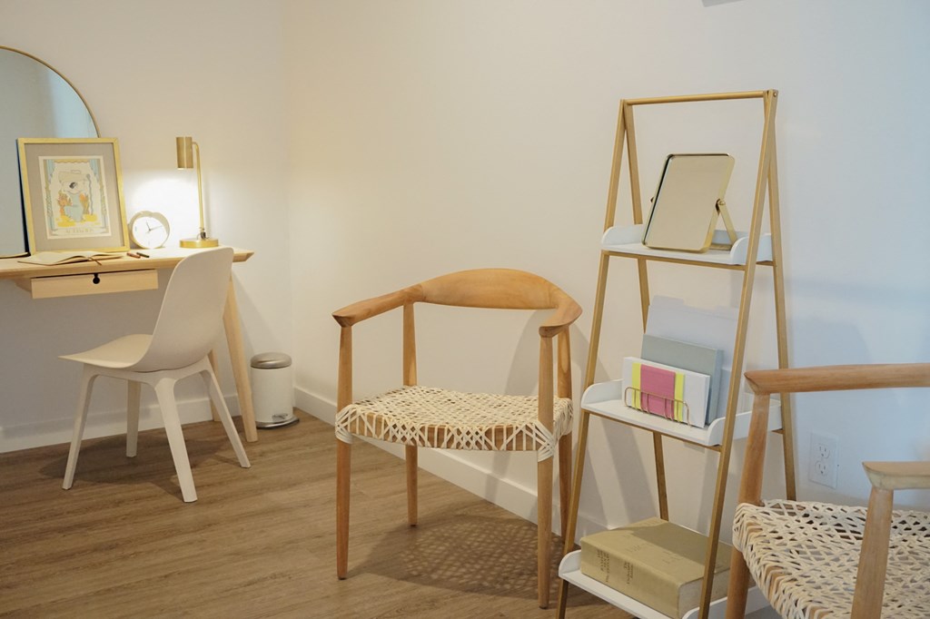 a room with a ladder and a chair and a desk and a mirror