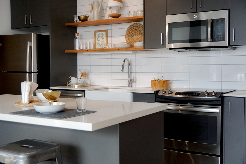 a kitchen with stainless steel appliances and white counter tops