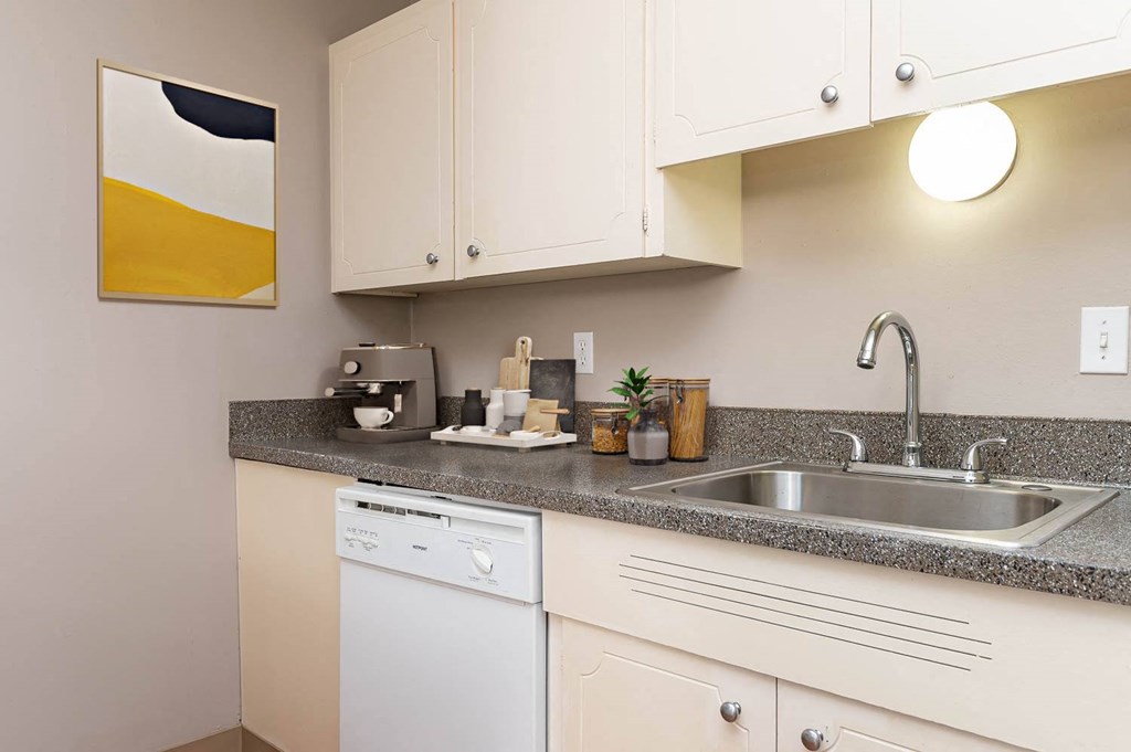 a kitchen with white cabinets and a sink