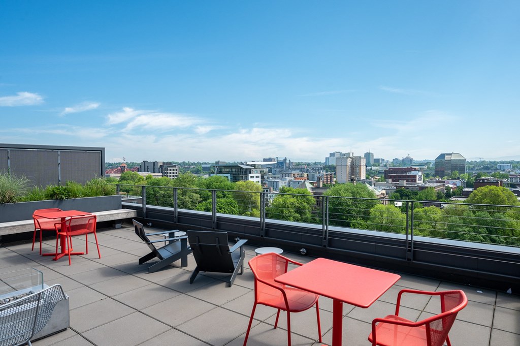 a terrace with tables and chairs and a view of the city