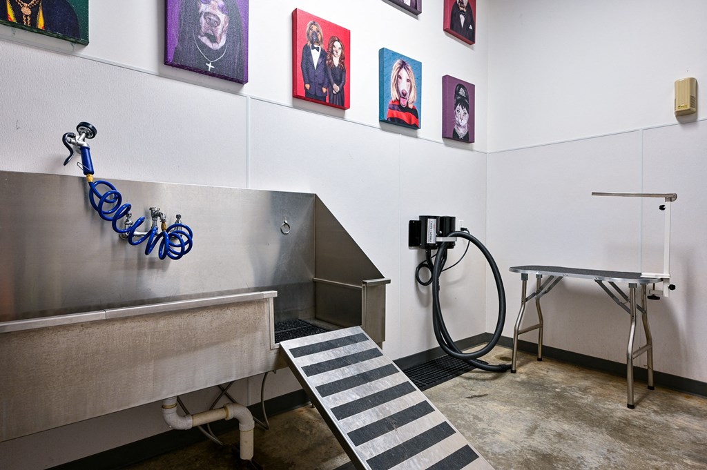 a gas pump and bench in a room with pictures on the wall