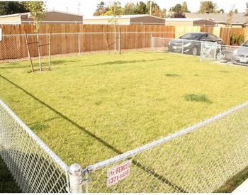 a fenced in yard with a no trespassing sign on the fence