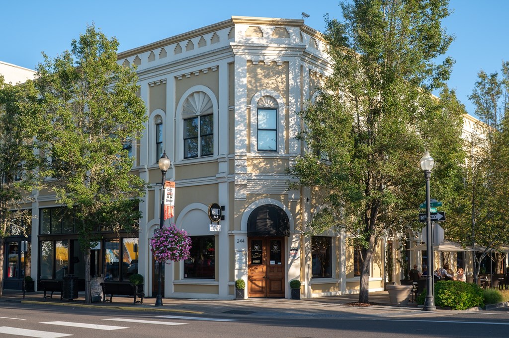 A building with a white facade and a large arched window.