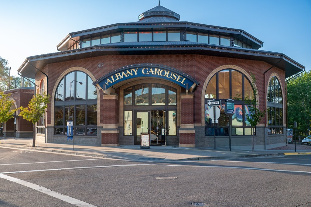 A brick building with a sign that says "Albany Carousel.".