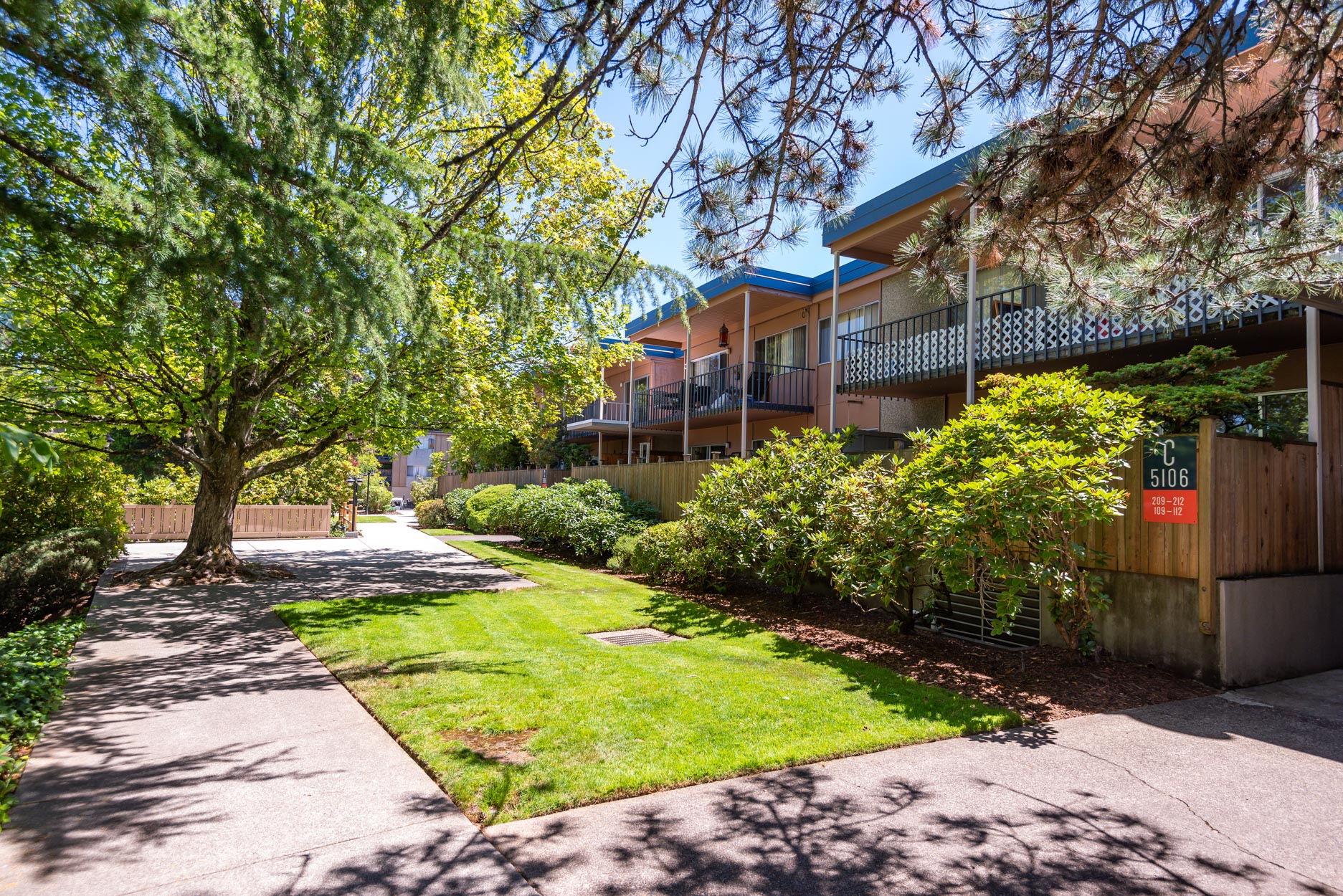 Exterior of building with grass in front and trees showing around the area.