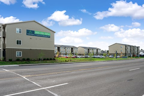 an empty street with an apartment building on the side of it