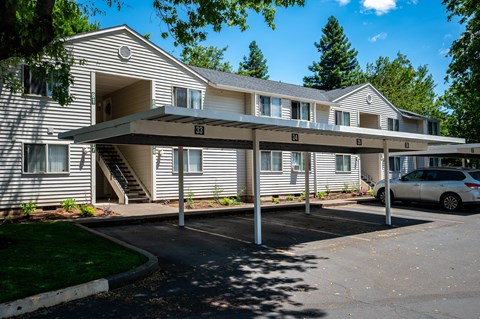 A large building with a covered walkway in front of it.