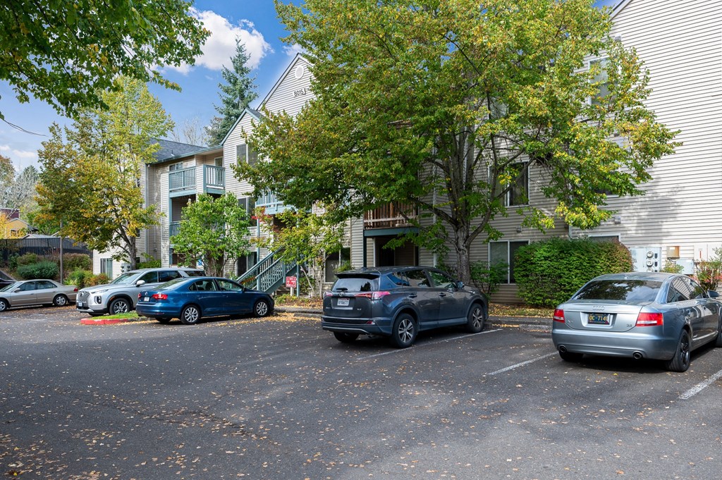 an apartment building with cars parked in front of it