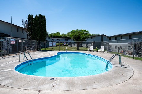 A round above ground pool with a fence around it.