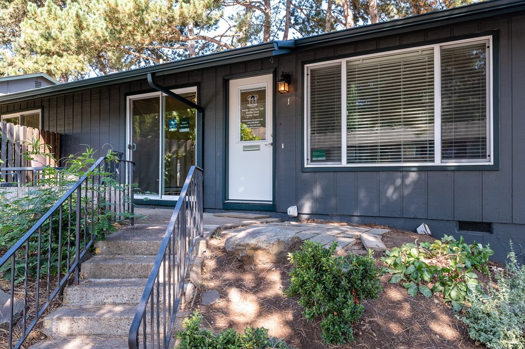the front entrance of a house with a white door and stairs