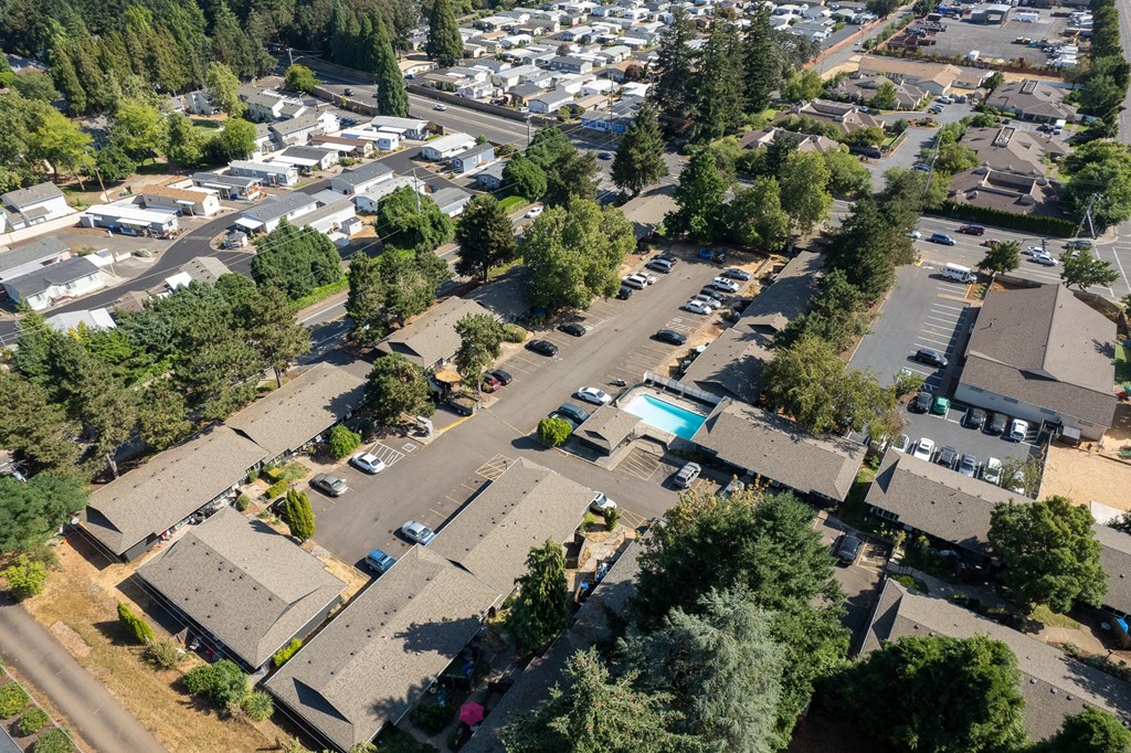 an aerial view of a neighborhood with cars parked in a parking lot