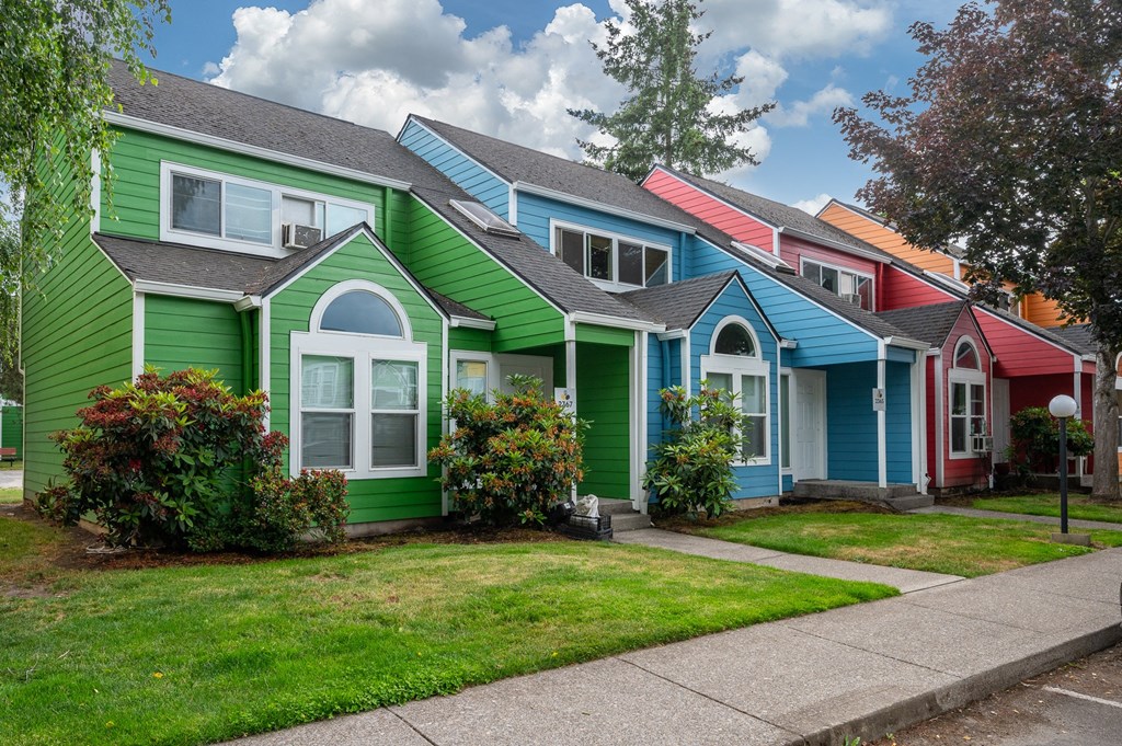 a row of colorful houses in a suburban neighborhood