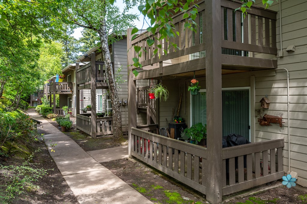 the front of a house with a porch and a sidewalk
