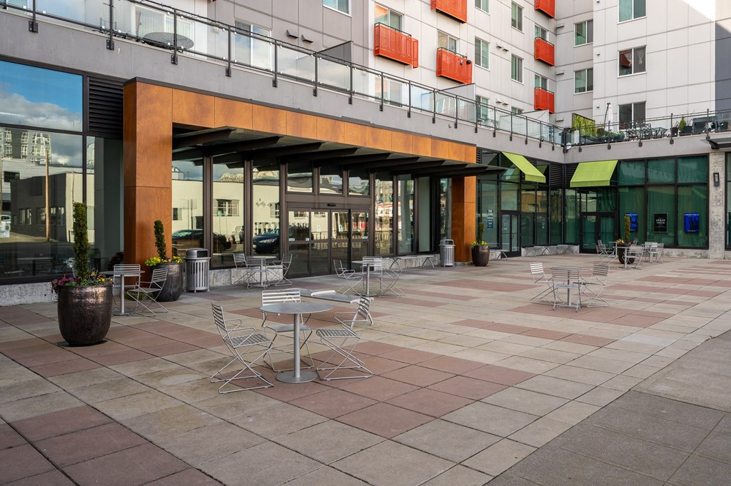 a courtyard with tables and chairs outside of a building