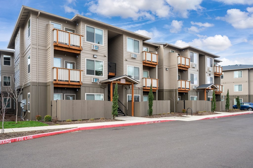 exterior view of willow tree place apartments in salem, oregon showing private patios and balconies