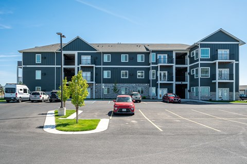 A large building with a parking lot in front of it.