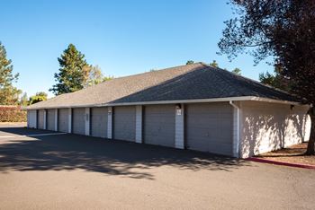 a white garage with white doors and a roof