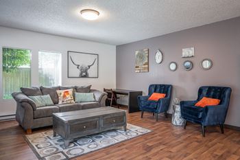 a living room with a couch and two chairs