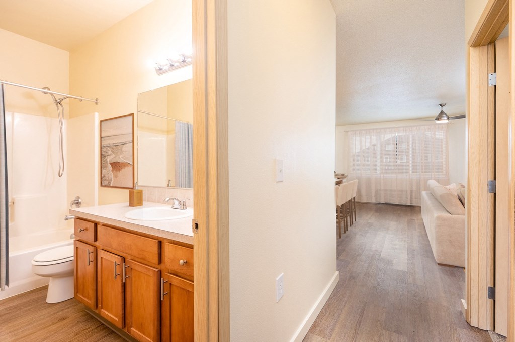 a bathroom with a shower and a sink and a toilet