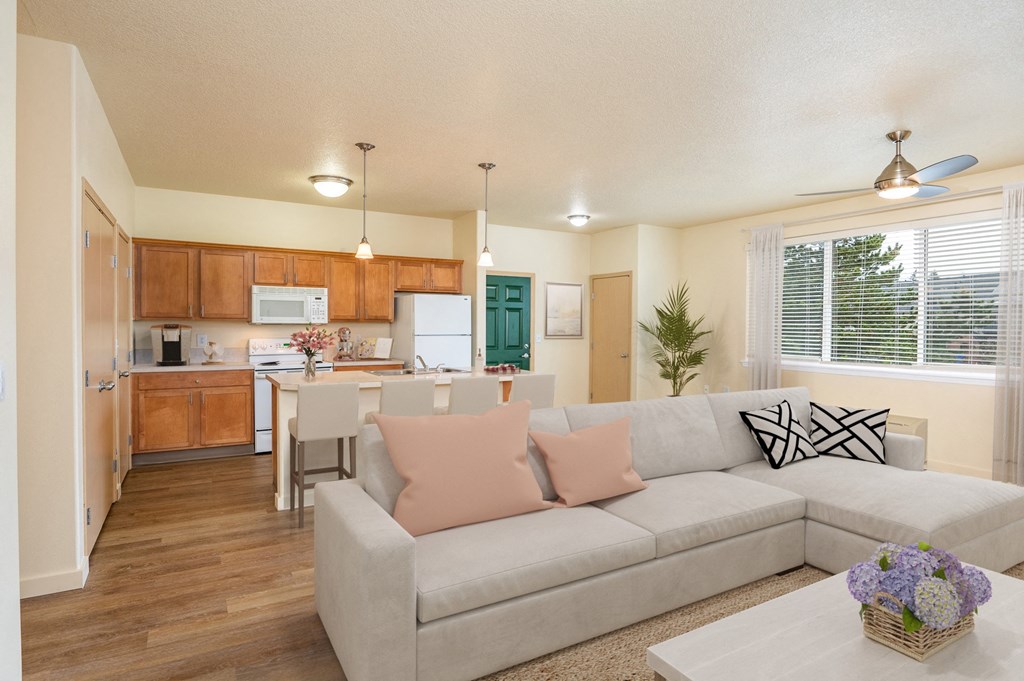 a living room and kitchen with a couch and a table