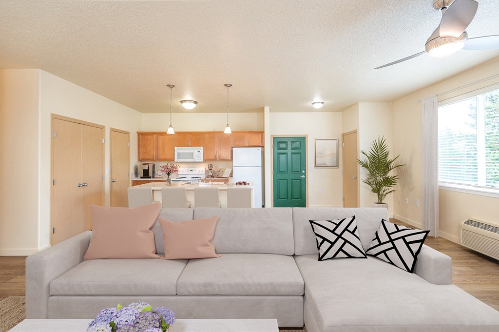 a living room with a couch and a table with pillows